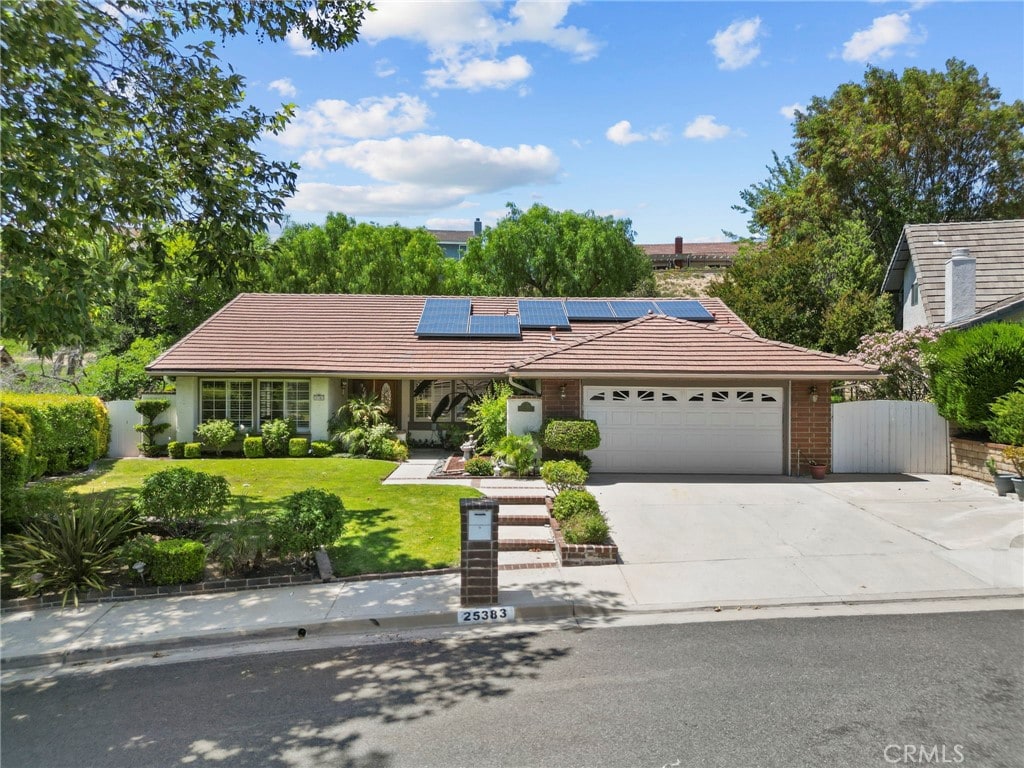 25383 Fortuna Dr, Valencia, CA 91355 - single story home with a tile roof, a garage, solar panels, and concrete driveway