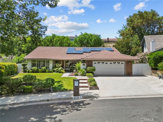 25383 Fortuna Dr, Valencia, CA 91355 - single story home with a tile roof, a garage, solar panels, and concrete driveway