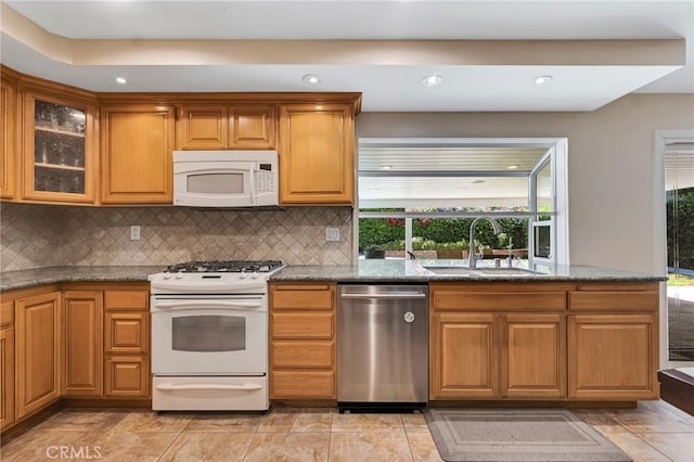 2146 N Brower St, Simi Valley, CA 93065 - kitchen with white appliances, tasteful backsplash, dark stone countertops, glass insert cabinets, and recessed lighting