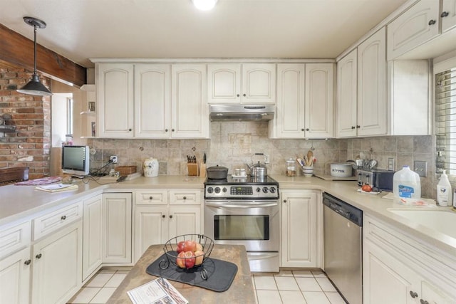2015 Temple Trl, Jamul, CA 91935 - kitchen featuring appliances with stainless steel finishes, under cabinet range hood, light tile patterned flooring, decorative backsplash, and light countertops