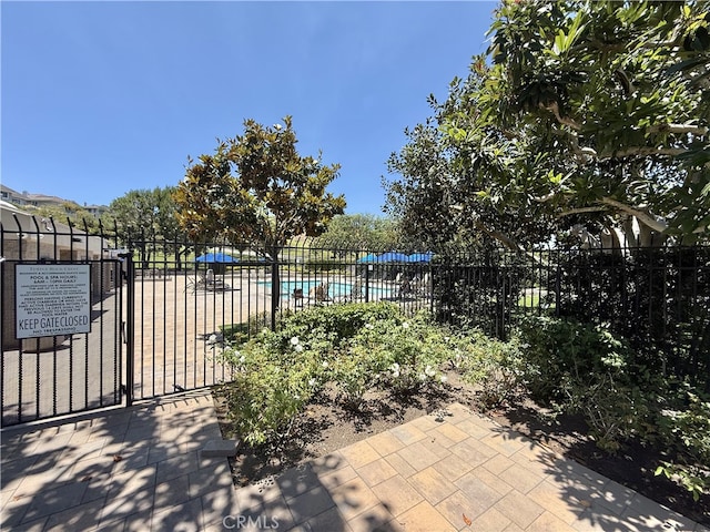 21 Centaurus Unit 3, Irvine, CA 92603 - view of patio / terrace featuring a community pool and a gate