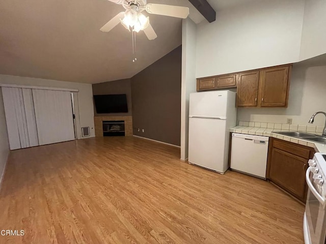 109 B St, Fillmore, CA 93015 - kitchen with white appliances, tile counters, ceiling fan, high vaulted ceiling, and a tiled fireplace