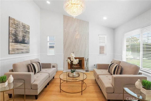 17824 Holmes Ave, Cerritos, CA 90703 - living room featuring vaulted ceiling, wainscoting, a chandelier, recessed lighting, and a decorative wall