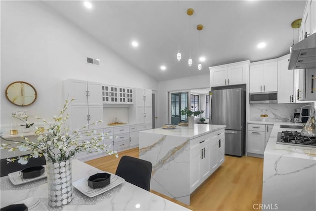 17824 Holmes Ave, Cerritos, CA 90703 - kitchen with stainless steel appliances, a center island, light wood-style flooring, white cabinetry, and recessed lighting