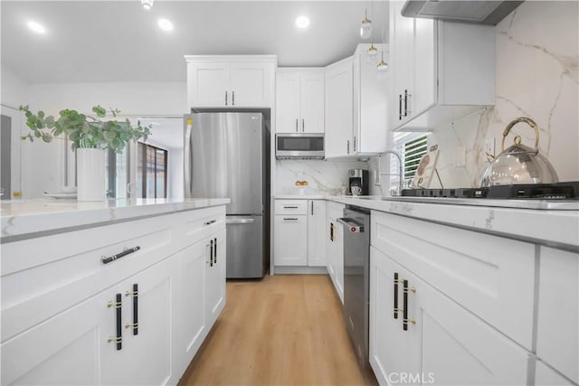 17824 Holmes Ave, Cerritos, CA 90703 - kitchen with stainless steel appliances, white cabinets, tasteful backsplash, light wood-type flooring, and recessed lighting