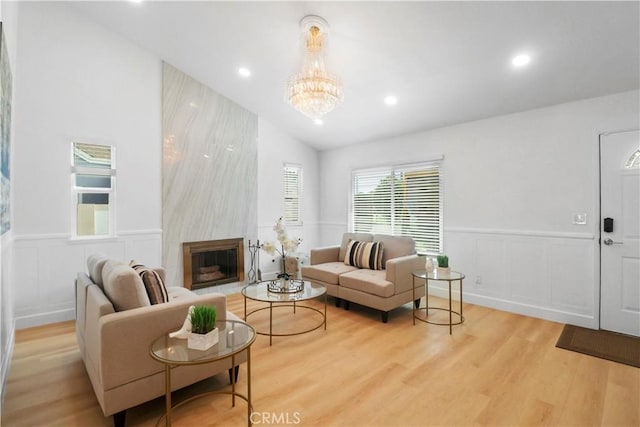 17824 Holmes Ave, Cerritos, CA 90703 - living area featuring wainscoting, wood finished floors, a chandelier, recessed lighting, and vaulted ceiling