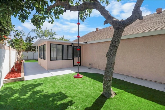 17824 Holmes Ave, Cerritos, CA 90703 - back of house featuring stucco siding, a fenced backyard, a shingled roof, a patio area, and a sunroom