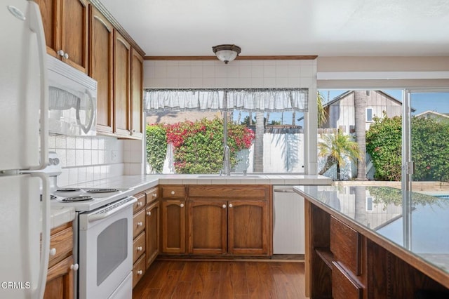 1310 Anza Ct, Oxnard, CA 93035 - kitchen with white appliances, decorative backsplash, dark wood-type flooring, brown cabinetry, and tile counters