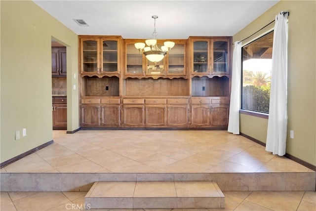 19996 Eyota Rd, Apple Valley, CA 92308 - unfurnished dining area with light tile patterned flooring and a chandelier