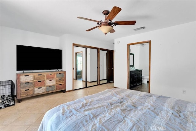 19996 Eyota Rd, Apple Valley, CA 92308 - tiled bedroom with ceiling fan, connected bathroom, and two closets