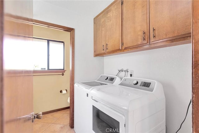 19996 Eyota Rd, Apple Valley, CA 92308 - washroom featuring washing machine and clothes dryer, cabinet space, and light tile patterned floors