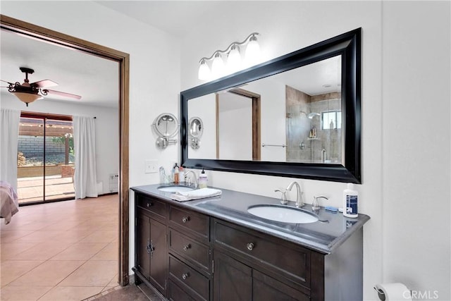 19996 Eyota Rd, Apple Valley, CA 92308 - bathroom featuring double vanity, tiled shower, tile patterned flooring, and a ceiling fan