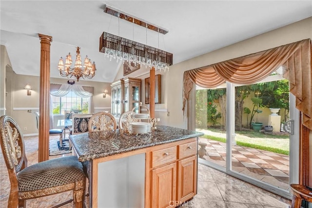 3486 Santa Clara Cir, Costa Mesa, CA 92626 - kitchen with dark stone counters, a chandelier, and a kitchen island