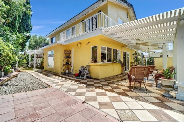 3486 Santa Clara Cir, Costa Mesa, CA 92626 - back of house featuring a balcony, a pergola, ceiling fan, a patio, and stucco siding