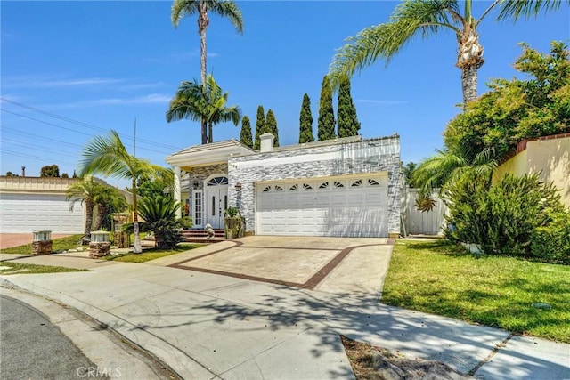 3486 Santa Clara Cir, Costa Mesa, CA 92626 - view of front of property with concrete driveway, a garage, stone siding, and a front yard