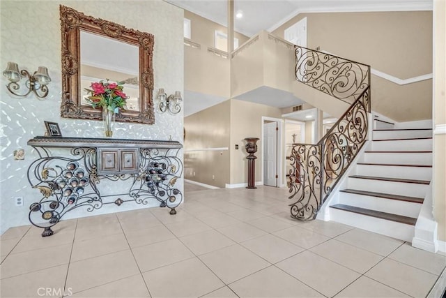 3486 Santa Clara Cir, Costa Mesa, CA 92626 - entryway featuring a towering ceiling, stairway, tile patterned floors, crown molding, and wallpapered walls