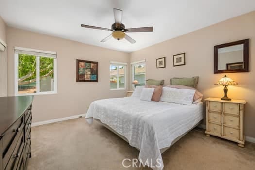 2968 Casitas Ave, Altadena, CA 91001 - carpeted bedroom with multiple windows and a ceiling fan