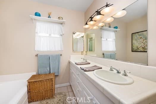 2968 Casitas Ave, Altadena, CA 91001 - bathroom featuring double vanity, a garden tub, and tile patterned floors