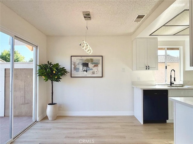 1850 Pritchard Way, Hacienda Heights, CA 91745 - unfurnished dining area with light wood-style flooring, plenty of natural light, and a textured ceiling