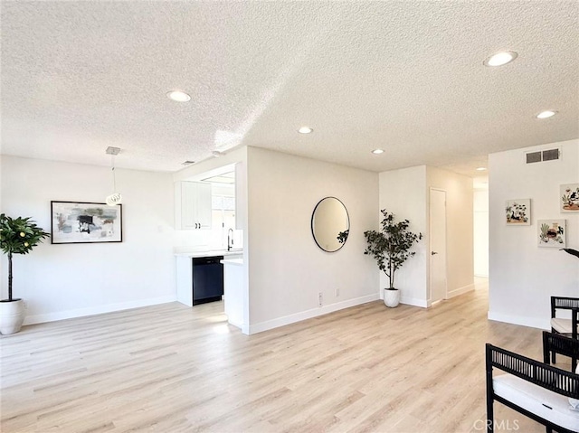 1850 Pritchard Way, Hacienda Heights, CA 91745 - unfurnished living room featuring a textured ceiling, light wood-style floors, and recessed lighting