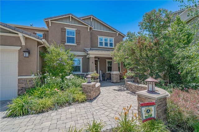 22348 Driftwood Ct, Saugus, CA 91350 - view of front of property with stucco siding, board and batten siding, and a garage