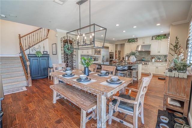 22348 Driftwood Ct, Saugus, CA 91350 - dining room with stairway, wood finished floors, recessed lighting, and crown molding