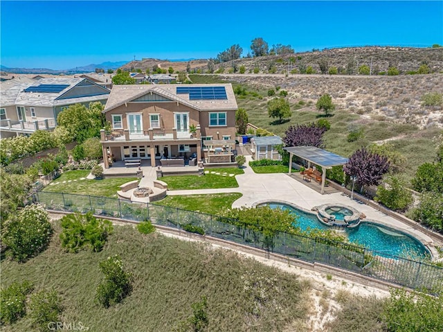 22348 Driftwood Ct, Saugus, CA 91350 - rear view of house featuring roof mounted solar panels, a fenced backyard, a patio, and a balcony