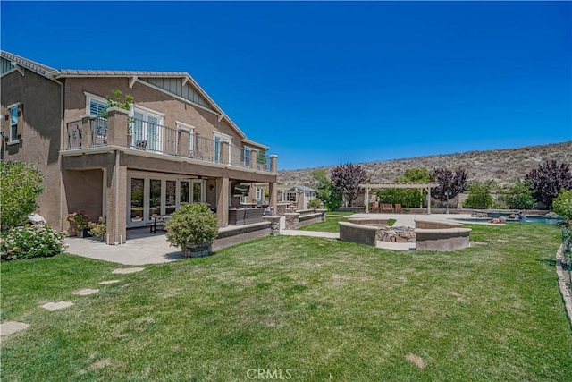 22348 Driftwood Ct, Saugus, CA 91350 - view of green lawn featuring a patio, a balcony, and french doors