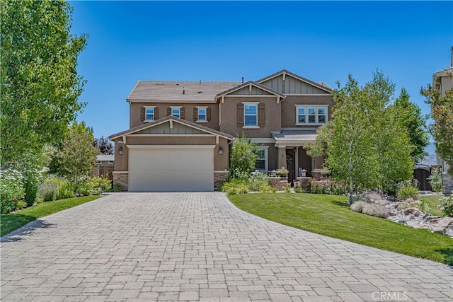22348 Driftwood Ct, Saugus, CA 91350 - craftsman-style home with stucco siding, decorative driveway, a garage, stone siding, and a front yard