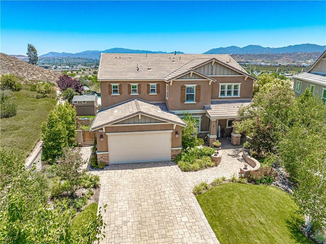22348 Driftwood Ct, Saugus, CA 91350 - view of front of house featuring stucco siding, a mountain view, stone siding, and driveway