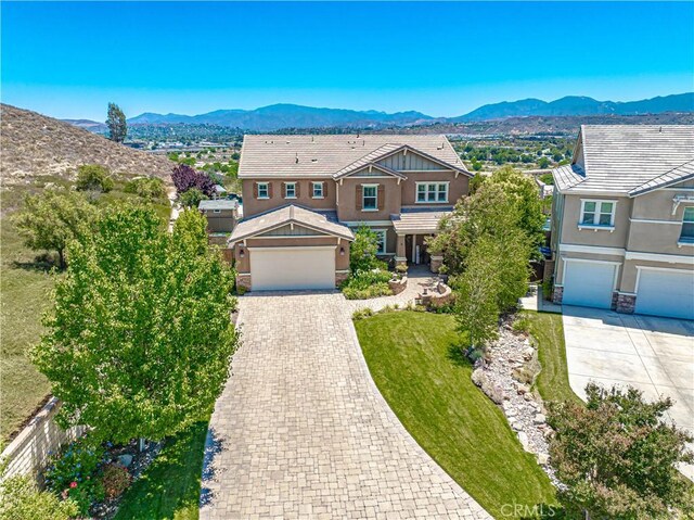 22348 Driftwood Ct, Saugus, CA 91350 - craftsman house featuring driveway, a mountain view, stucco siding, an attached garage, and a front lawn