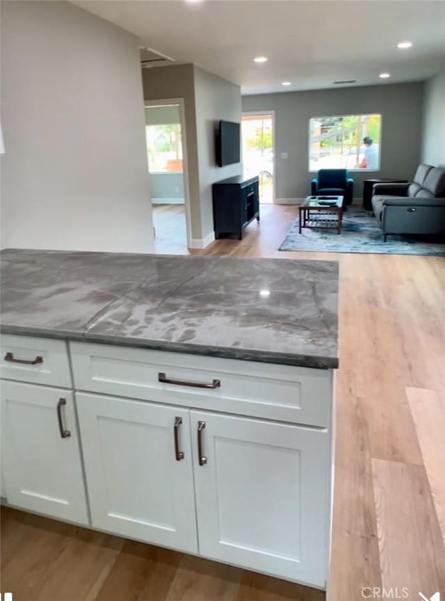 3520 Grand Ave, Huntington Park, CA 90255 - kitchen with open floor plan, light wood-style flooring, white cabinets, and recessed lighting