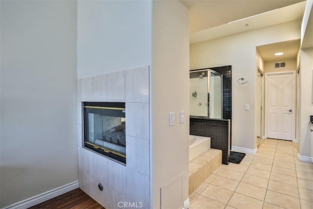 5 Arese Aisle, Irvine, CA 92606 - bathroom with a garden tub, tile patterned floors, a stall shower, and a tile fireplace