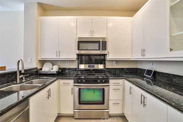 5 Arese Aisle, Irvine, CA 92606 - kitchen with stainless steel appliances, dark stone counters, and white cabinetry