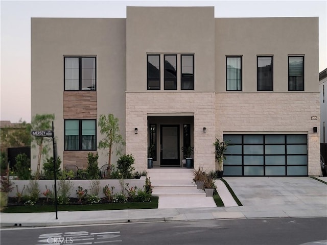 20042 W Mersey Ln, Porter Ranch, CA 91326 - view of front of property with stone siding, a garage, concrete driveway, and stucco siding