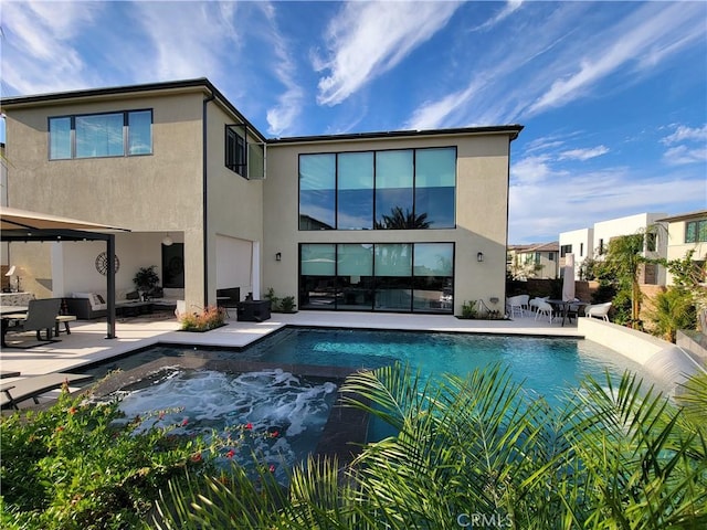 20042 W Mersey Ln, Porter Ranch, CA 91326 - back of house featuring stucco siding, a patio, and an outdoor pool