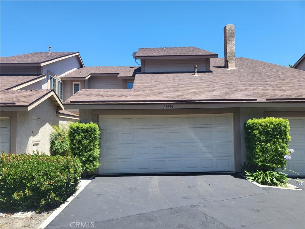 21434 Cypresswood, Lake Forest, CA 92630 - view of front of property featuring asphalt driveway, a garage, and a chimney