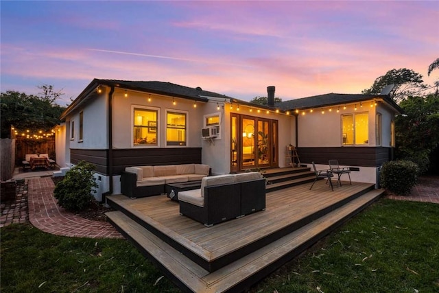 5923 Abernathy Dr, Los Angeles, CA 90045 - back of property at dusk with outdoor lounge area, a wooden deck, stucco siding, and cooling unit