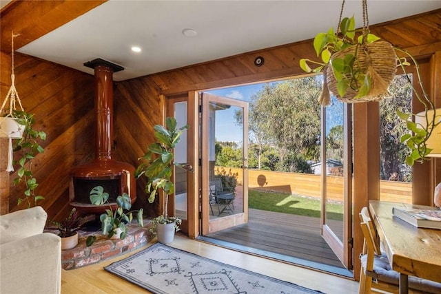 5923 Abernathy Dr, Los Angeles, CA 90045 - doorway to outside with wood walls, a wood stove, and wood finished floors