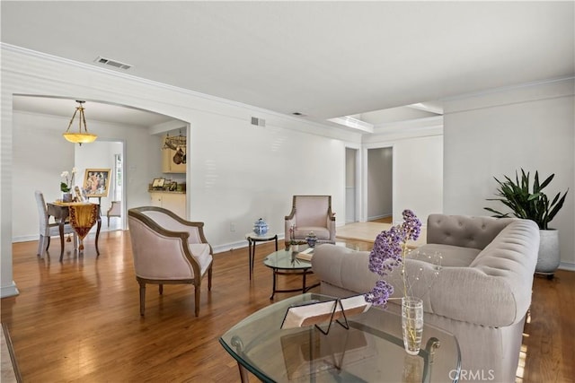 13232 Lorca Rd, La Mirada, CA 90638 - living area featuring wood finished floors, crown molding, and arched walkways