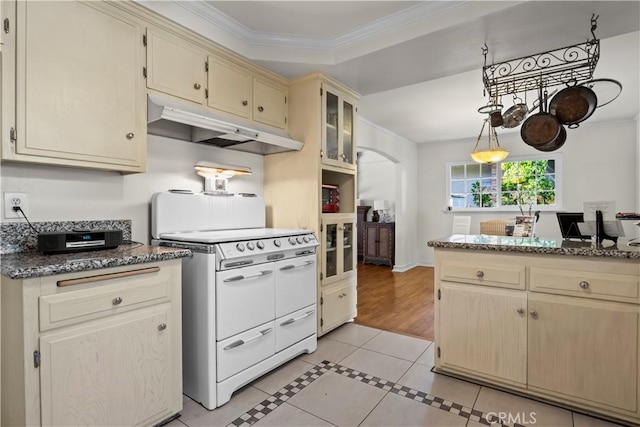 13232 Lorca Rd, La Mirada, CA 90638 - kitchen with under cabinet range hood, double oven range, crown molding, light tile patterned floors, and arched walkways