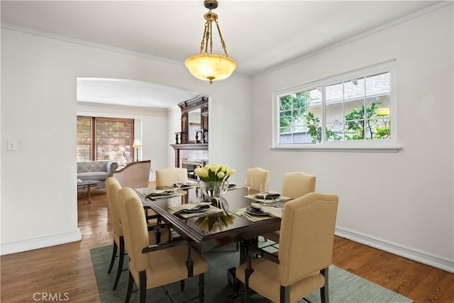 13232 Lorca Rd, La Mirada, CA 90638 - dining space with arched walkways, wood finished floors, and ornamental molding