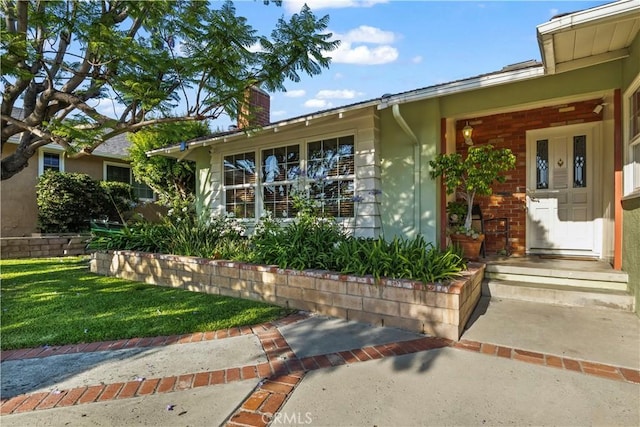 13232 Lorca Rd, La Mirada, CA 90638 - property entrance featuring a chimney and a lawn