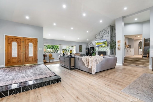 95 Buckskin Rd, Bell Canyon, CA 91307 - living area with light wood-style floors, a premium fireplace, recessed lighting, arched walkways, and high vaulted ceiling