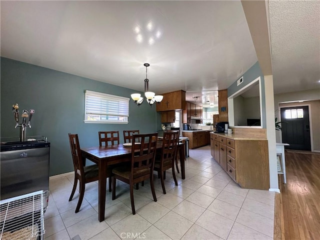 22709 Elm Ave, Torrance, CA 90505 - dining room featuring a chandelier, plenty of natural light, and light tile patterned floors