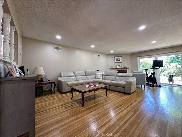 22709 Elm Ave, Torrance, CA 90505 - living room with a textured ceiling, light wood-style floors, and recessed lighting