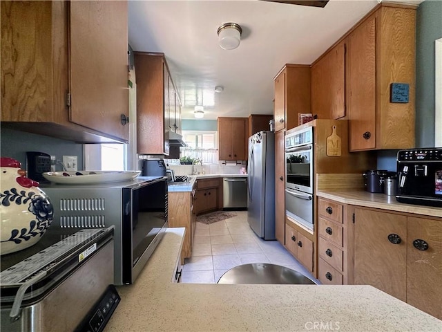 22709 Elm Ave, Torrance, CA 90505 - kitchen featuring appliances with stainless steel finishes, a warming drawer, brown cabinets, and light countertops