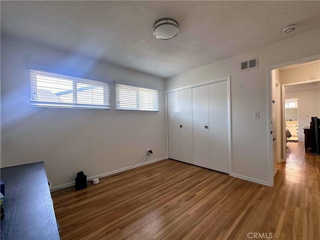 22709 Elm Ave, Torrance, CA 90505 - unfurnished bedroom featuring wood finished floors, a textured ceiling, and a closet
