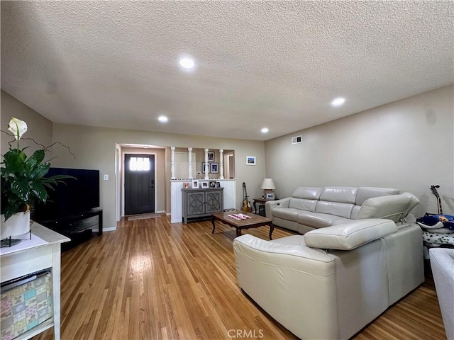 22709 Elm Ave, Torrance, CA 90505 - living area with light wood-type flooring, a textured ceiling, and recessed lighting