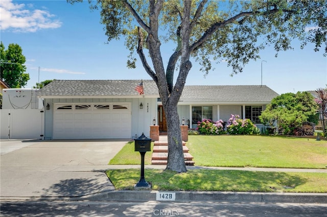 1428 N Erin Ave, Upland, CA 91786 - single story home with an attached garage, concrete driveway, a front lawn, a gate, and a shingled roof